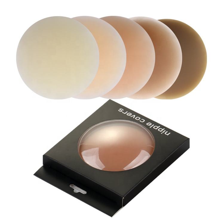 Round silicone nipple covers in five skin tones above NipLift retail box